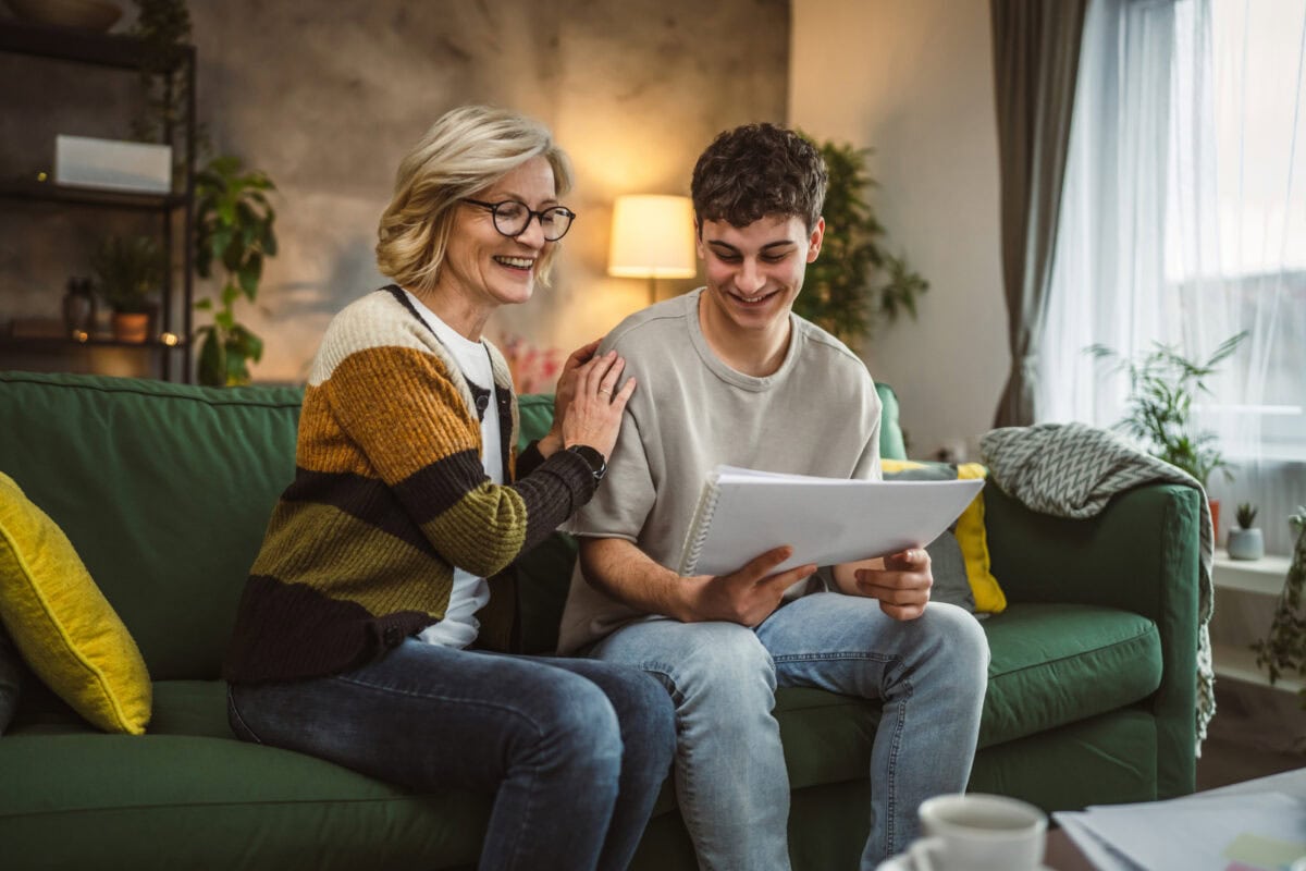 student caucasian man study with help of his tutor professor or mother